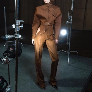 Detail of dark brown fashion set with scarf-neck top and side-button wide-leg pants