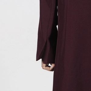 Detail view of burgundy trench coat sleeve featuring a stylish slit cuff design