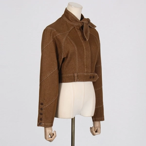 Detail of brown cropped jacket featuring bow tie collar and contrast stitching