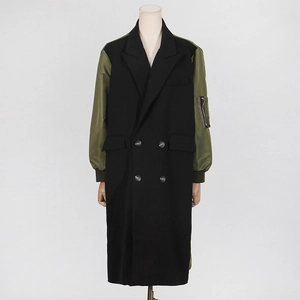 Detail of hybrid trench coat with black suit lapels and green satin aviator sleeves