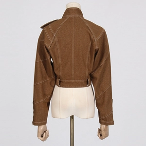 Detail view of brown crop jacket featuring white contrast stitching and twill texture