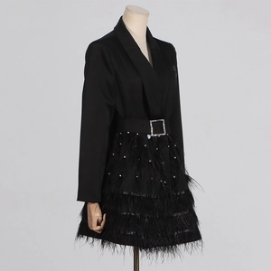 Dettaglio dell'abito blazer nero con rifiniture in piume di struzzo e perle decorative