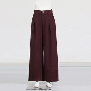 Detail view of high-waist wide-leg trousers in deep burgundy with front pleat accents