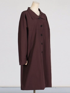 Elegant long brown single-breasted trench coat with classic lapel and side pockets