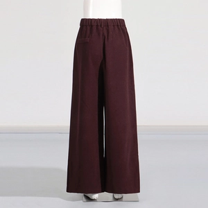 Detail view of burgundy wide-leg pants featuring elastic high waist and back pocket
