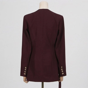 Detail view of the back seams and four decorative buttons on the sleeve of a purple blazer