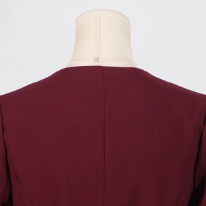 Detail view of the back collar and stitching on the wine red slim-fit top