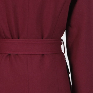 Close-up of burgundy wool jacket waist with matching belt and detailed stitching