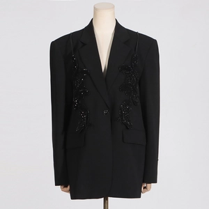 Detail of black mid-length blazer featuring intricate sequined butterfly embroidery
