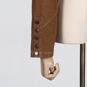 Detail of brown sleeve cuffs with five decorative buttons and white contrast stitching