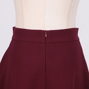 Close-up of burgundy skirt waist with seamless invisible zipper and fine fabric texture