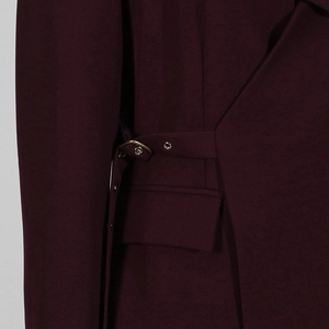 Detail of burgundy blazer showing adjustable waist belt with bronze buckle and pocket
