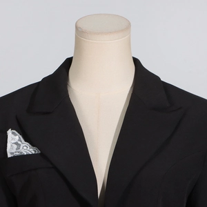 Close-up of black blazer with elegant white lace trim detail on the front pocket