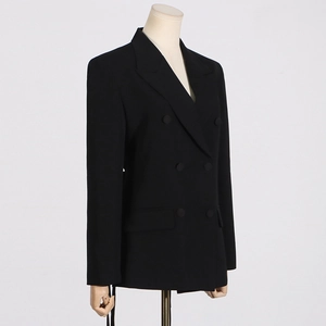 Detailed 3/4 view of a black double-breasted blazer with peaked lapels and flap pockets