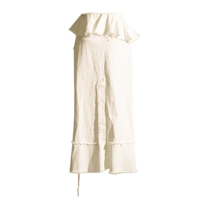 Close-up of white denim skirt with asymmetric ruffle waist and frayed hem detail