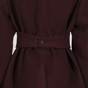 Detailed view of dark burgundy wool coat back featuring a waist belt and dual buttons