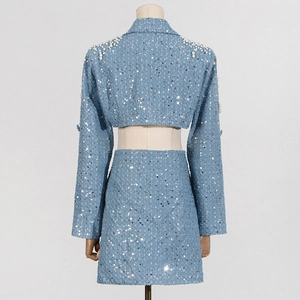 Detail of light blue sequined suit with white pearls on shoulders and mini skirt