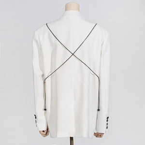 Detail of white blazer back showing black criss-cross lacing with small bead accents
