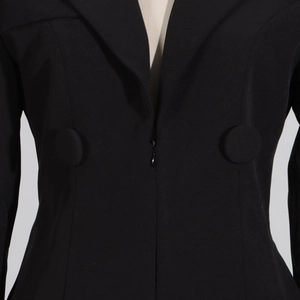 Detail of waist zip and decorative fabric buttons on black lace ruffled suit bodysuit