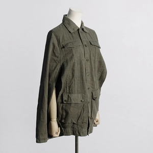 Detail of army green cargo jacket with four pockets and unique cape-style sleeves design