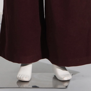 Close-up of deep burgundy wide-leg trousers in premium thick wool fabric with smooth hem