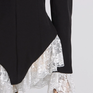 Detailed view of the elegant lace trim and ruffle edge design on a black blazer bodysuit