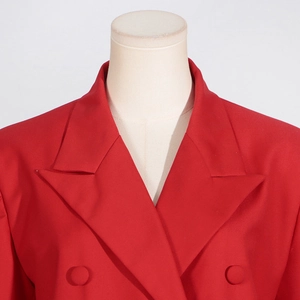 Detailed view of red double-breasted blazer with classic lapels and woven texture