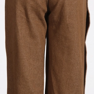 Detailed close-up of brown twill trousers featuring straight-leg cut and neat stitching