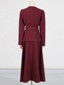 Back view of burgundy long sleeve crop jacket and long skirt set with waist belt
