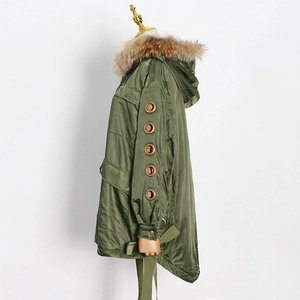Detailed side view of parka sleeve featuring decorative gold metal eyelets and fur collar
