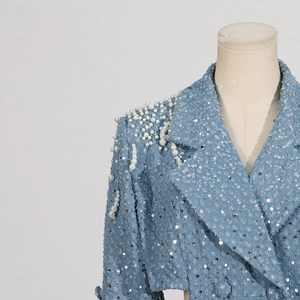 Detail of light blue tweed blazer featuring intricate white pearl and silver sequin embroidery