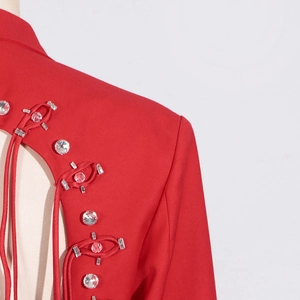 Detail of red blazer collar with rhinestones, silver sequins and braided closure
