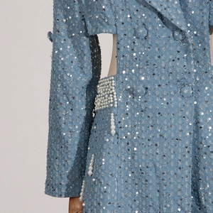 Detail of light blue dress with silver sequins, pearl waist cut-out and premium texture