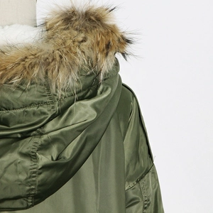 Detail of army green parka showing the soft faux fur collar and windproof fabric texture