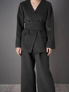Women's black two-piece suit with belted double-breasted jacket and wide-leg trousers