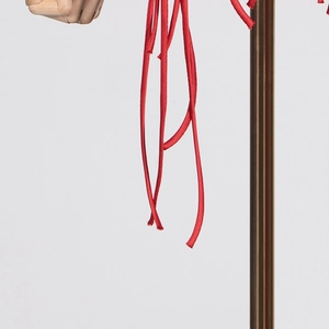 Detail of vivid red fringe tassels and satin ties on a stylish blazer garment