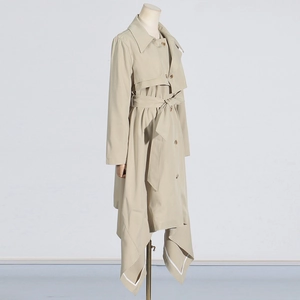 Close-up of khaki trench coat featuring a double-breasted design and asymmetric hemline