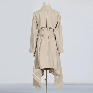 Detail view of khaki trench coat back with storm flap and irregular hemline design