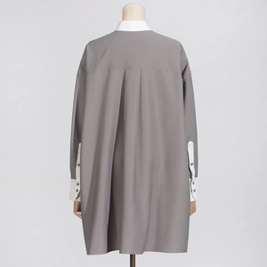 Detail of grey shirt back featuring contrast white collar and elegant center pleat