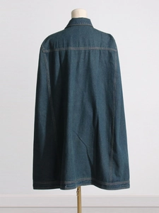 Back view of stylish dark blue denim cape jacket with contrast stitching and loose silhouette
