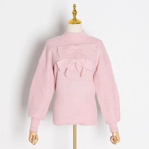 Close-up of pink knit sweater featuring elegant 3D bow details and high neck design