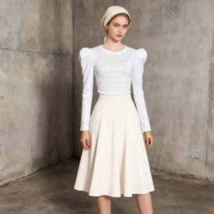 Detail of elegant white long sleeve puff sleeve top with high waist skirt and headscarf