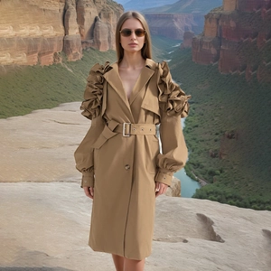 Detail of ruffled shoulders and waist belt on a long khaki trench coat for women