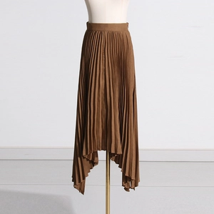 Detail of high waist pleated midi skirt with irregular hemline in brown fabric