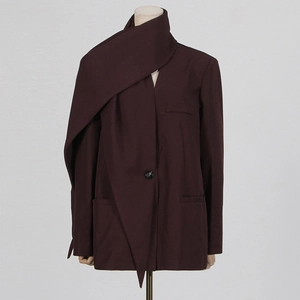 Detail view of dark brown oversized coat featuring a unique scarf-style collar and one button