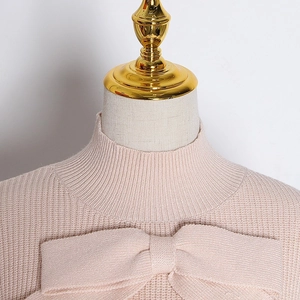 Detail of elegant knit sweater showing close-up of large bow and ribbed mock neck collar
