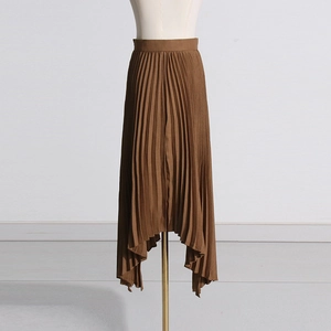 Detail of a brown pleated skirt with an irregular asymmetric hem and textured finish