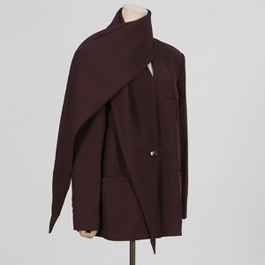 Detail of burgundy wool suit jacket featuring a unique built-in scarf neck wrap