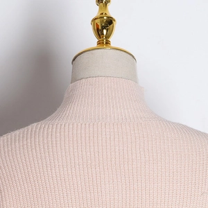 Close-up of pink ribbed knit sweater collar on a mannequin featuring a mock neck design