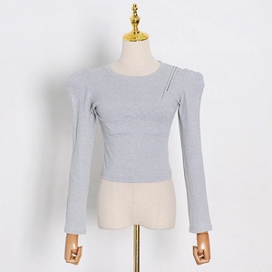 Detail of grey slim fit long sleeve top featuring puff shoulders and diagonal stitching